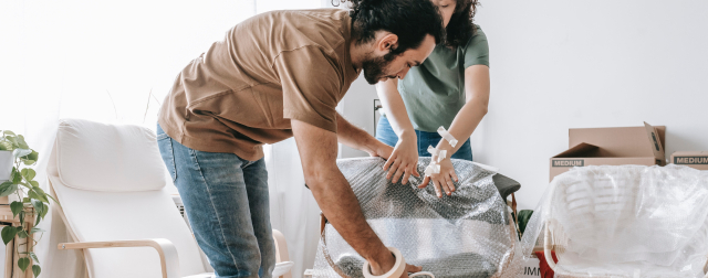 Students pack furniture with bubble wrap for a safe move